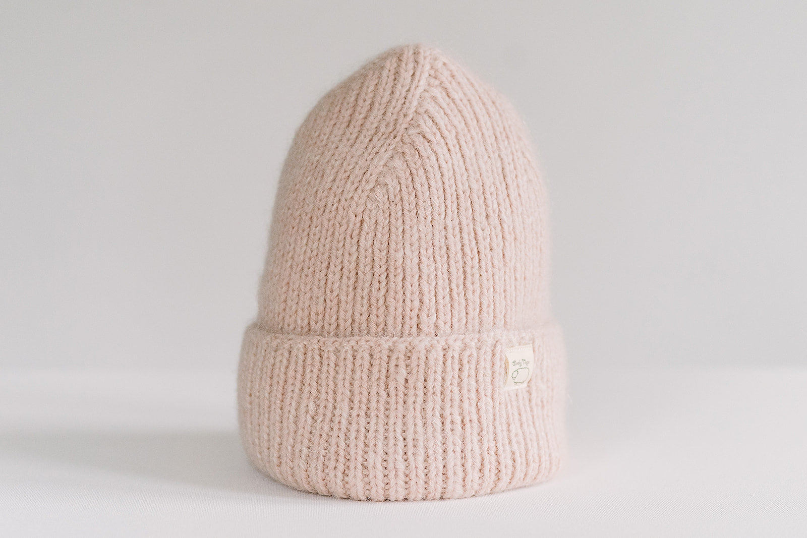 Hand-knitted Wooly Top hat in pink.