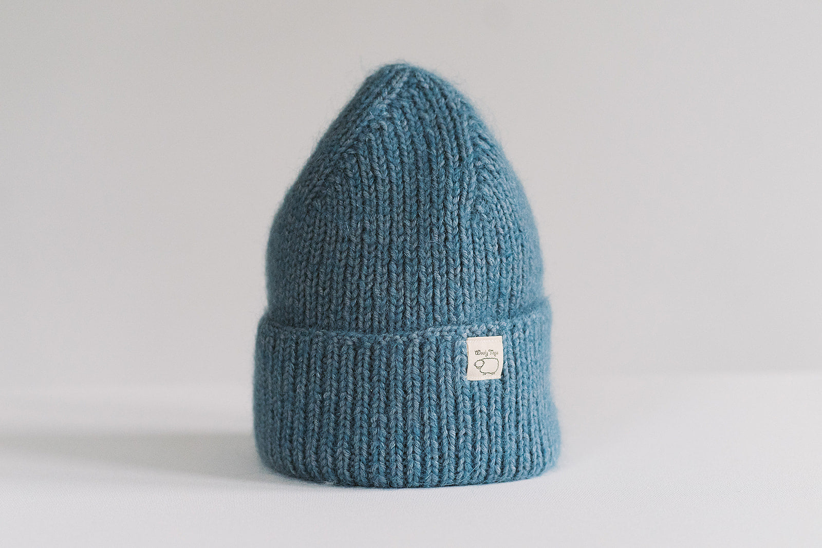 Hand-knitted Wooly Top hat in blue.