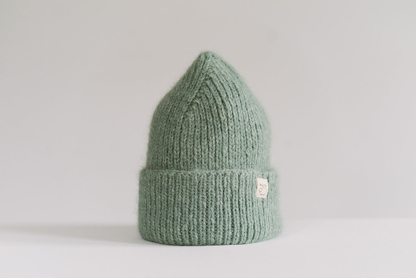 Hand-knitted Wooly Top hat in green.