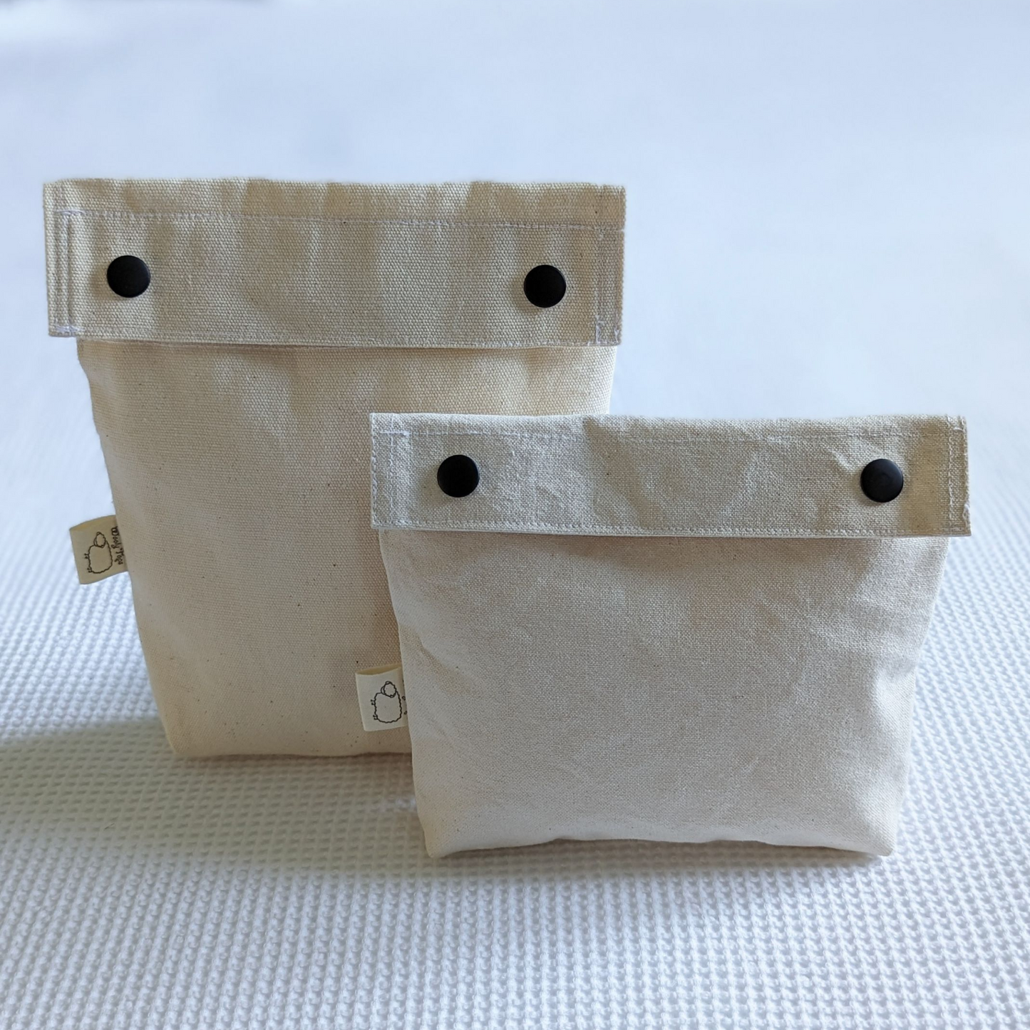 Wooly tops cotton canvas snap bags in large and small with black brass snaps.
