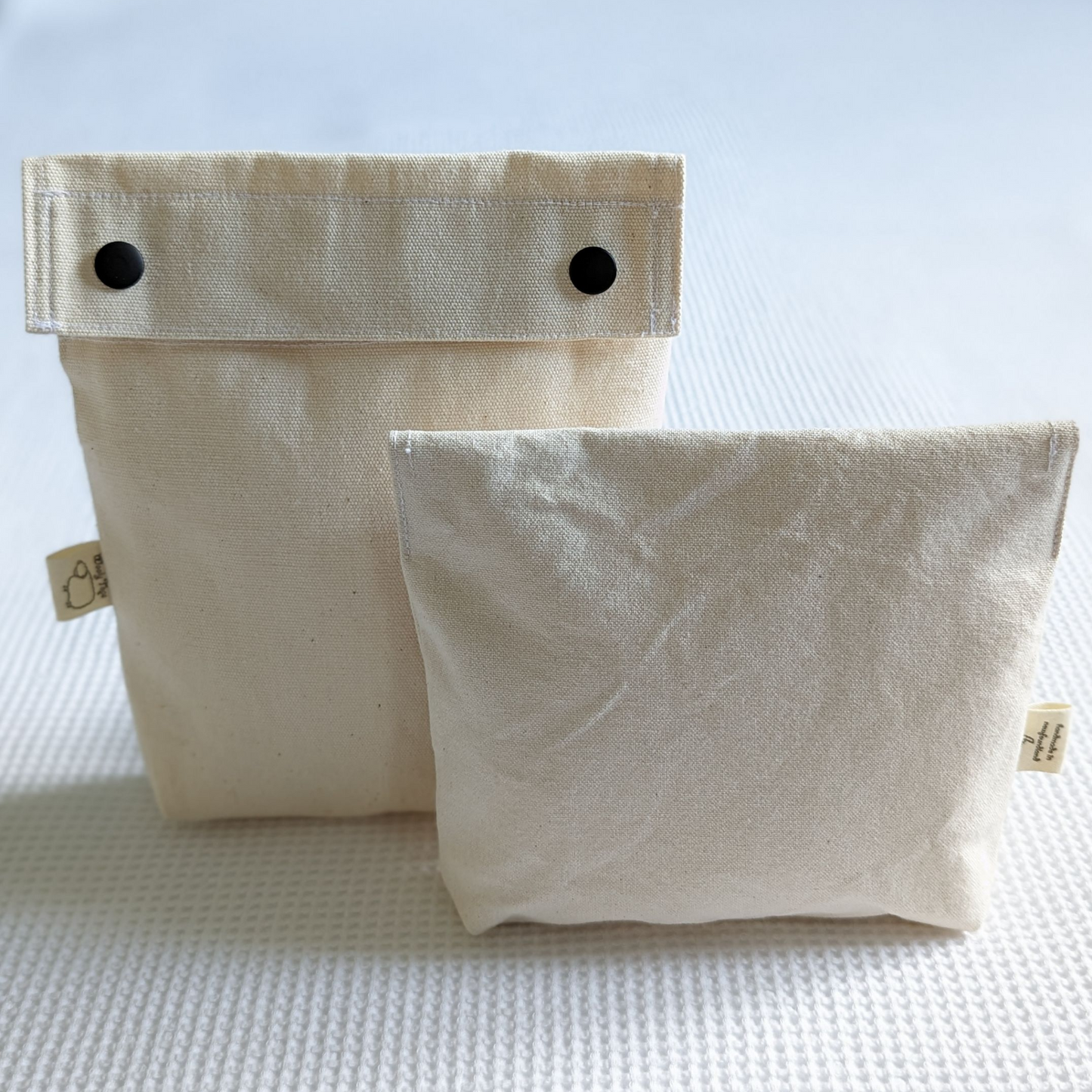 Wooly Tops cotton canvas snap bags in large and small with black brass snaps.