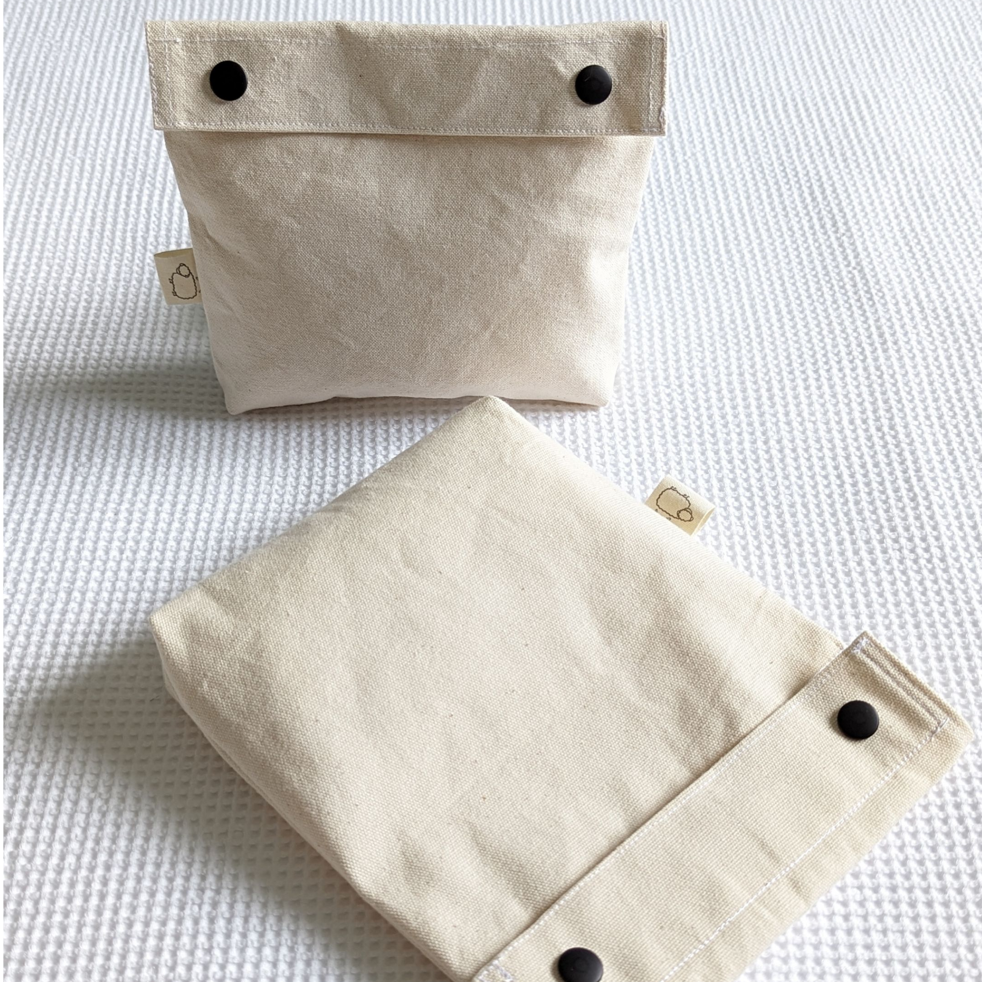 Wooly Tops cotton canvas snap bags in large and small with black brass snaps.