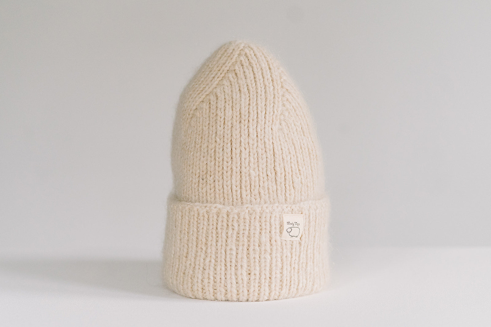 Hand-knitted Wooly Top hat in cream.